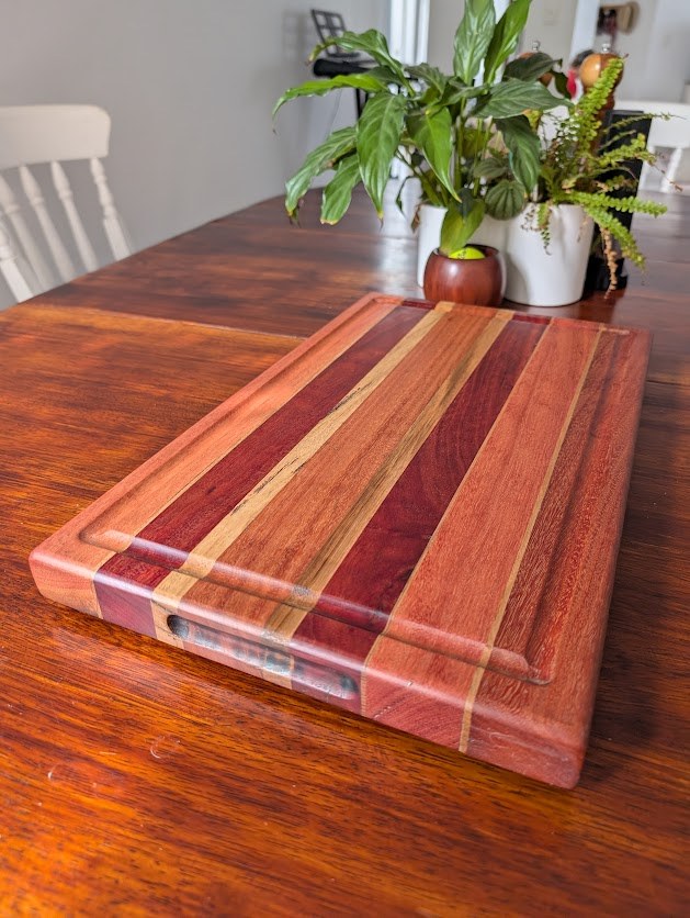 Angled view of Skipsey's Woodworking board with red hardwood stripes