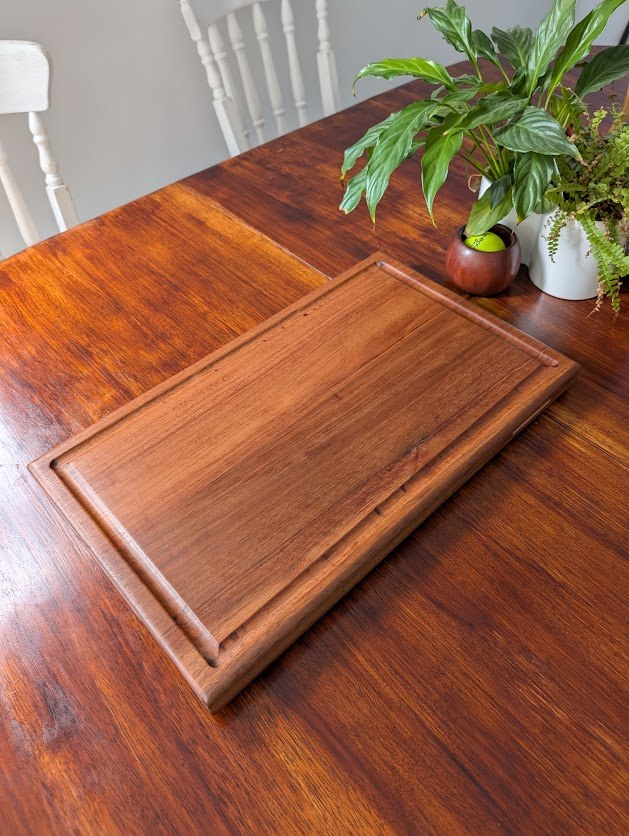 Close-up of hardwood chopping board showing smooth surface and thickness
