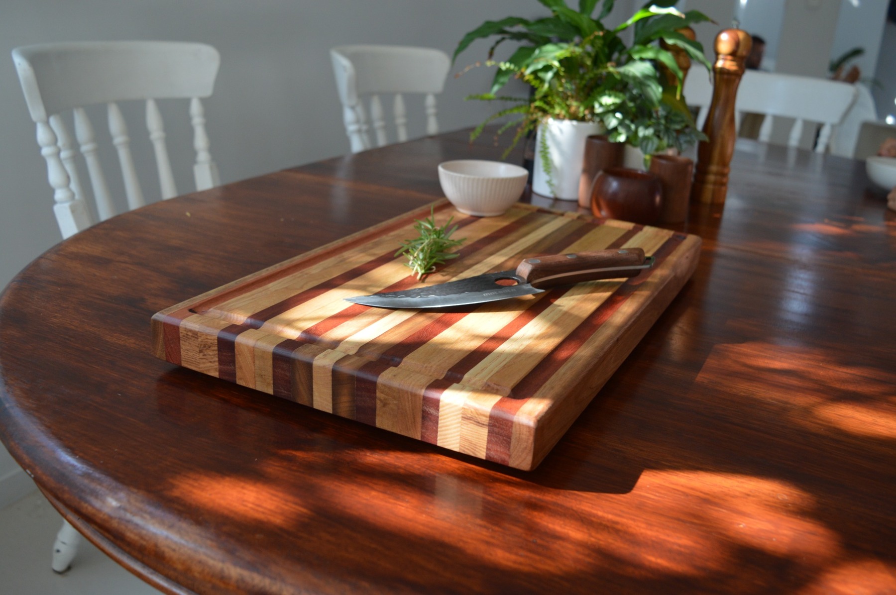 Skipsey's Woodworking handcrafted Australian hardwood chopping board with knife and herbs